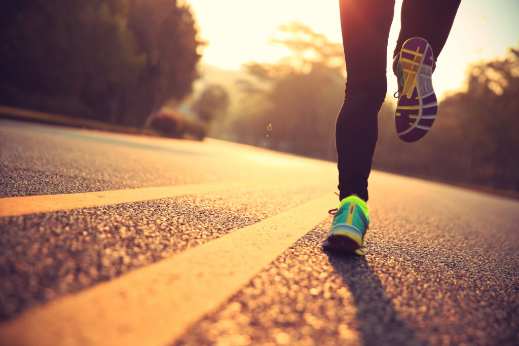 Woman running at sunrise.